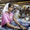 Young woman working in clothing factory