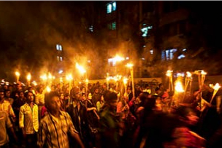 Protesters march with candles
