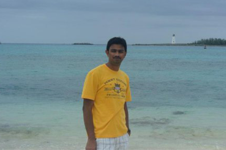 Photo of man standing near a beach