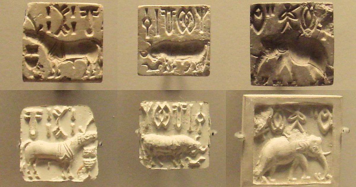 Three stamp seals and their impressions bearing Indus script characters alongside animals "unicorn" (left), bull (centre) and an elephant. | ALFGRN, CC BY-SA 2.0, via Wikimedia Commons