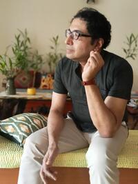 Ranjan Ghosh sitting on cushion